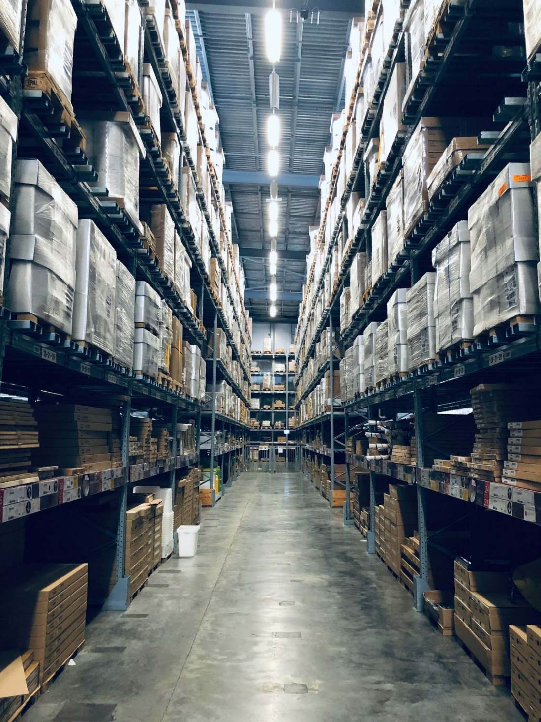 Palletized surplus equipment racked in a warehouse aisle